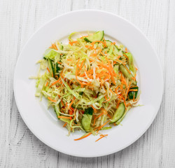 Fresh vegetable salad with cabbage, carrot, green onion and cucumber