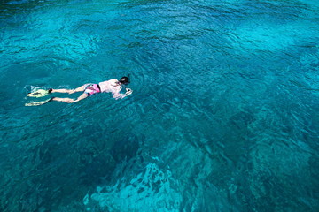 people snorkeling in the deep blue sea ocean of Andaman sea