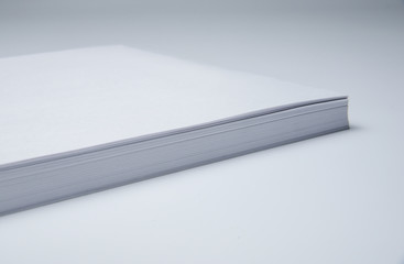 A stack of paper lies on a clean surface. Strict business style. Minimalism.