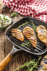 Grilled chicken breast on grilled pan with rice and green peas