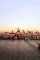 Naklejka premium Sunset view of St Paul's Cathedral and Millennium Bridge