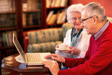 Senior couple reading news from the internet