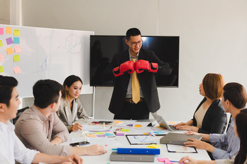 A group of Asian businessmen are discussing their work. Boxing business concept by presendent.