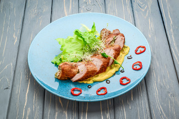 Baked beef stuffed with mushrooms and herbs with pumpkin puree and salad