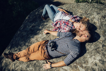Hipster couple in love having fun together posing in mountain.