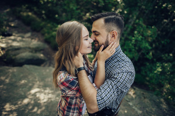 Hipster couple in love having fun together posing in mountain.
