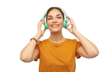 music, technology and people concept - happy young woman or teenage girl with headphones
