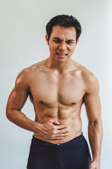 Fototapeta premium Asian man with muscular Injury to the stomach from exercise on White background