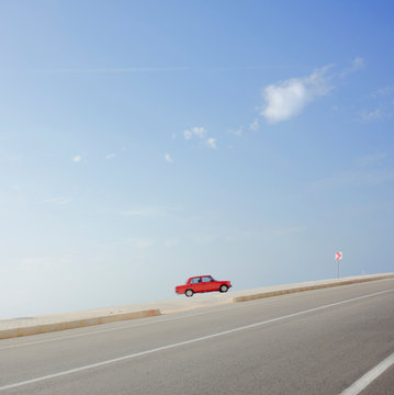Iconic Red Turkish Car by Sea