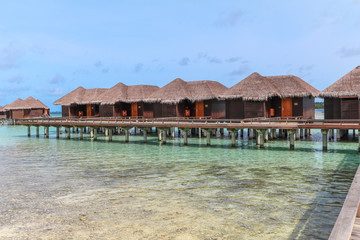 Amazing island in the Maldives ,wooden bridge and  beautiful  turquoise waters with  blue sky  background for for holiday ,summer, vacation .