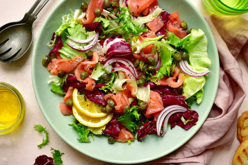 Mix of salad leaves with salted salmon. Top view with copy space.