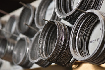 Special ring gasket for connecting two metal parts hang on the stand at the manufacturer of valves...