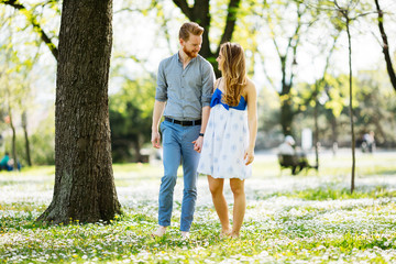 Fototapeta premium Beautiful couple taking a walk in city park