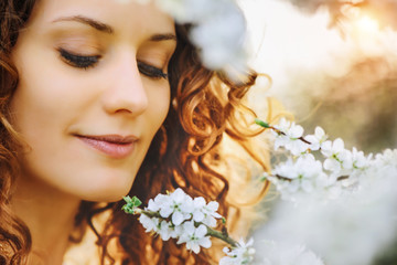 beautiful woman looking at the flower