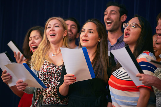 Multi-ethnic friends singing at choir practice in language school