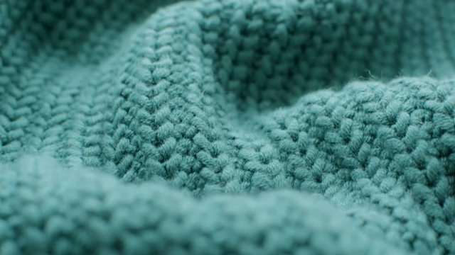 The texture of the fabric. Green knitted texture. Close-up. Can be used as a background. HD