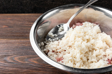 Raw meat mince with rice on dark wooden background.
