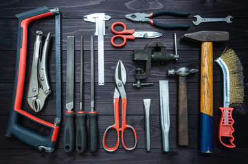Background from various tools on wooden workbench. top view