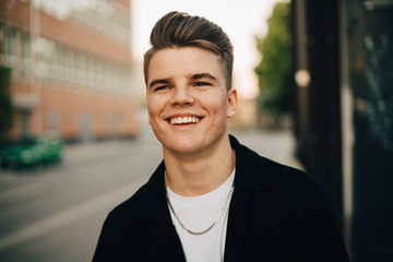 Smiling man walking on sidewalk in city