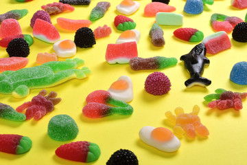 elevated view of jelly candies collection on yellow background