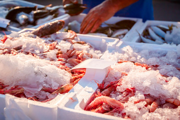 Fresh shrimps on Ice at outdoor fish flea market - Powered by Adobe