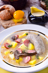a polish easter soup with homemade white sausage and mushrooms