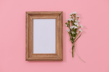 wooden frame mockup with fallen flowers in the background