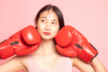 Young Asian woman with red boxing gloves.