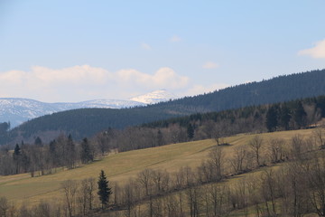 Fototapeta na wymiar Rudawy Janowickie Mountains during spring. Karkonosze Mountains, Śnieżka Mountain (snow-covered) in the background. Warm, sunny, calm day. Lower Silesia, Dolny Śląsk, Poland, Polska, Polen