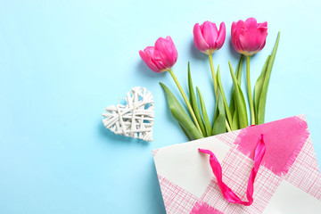pink tulips in pink bag and decorative heart