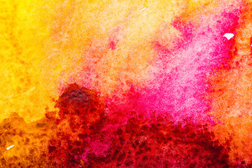 top view of red, pink, yellow watercolor spills with copy space