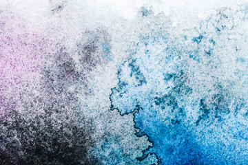 Fototapeta premium top view of blue and grey watercolor spills on white paper