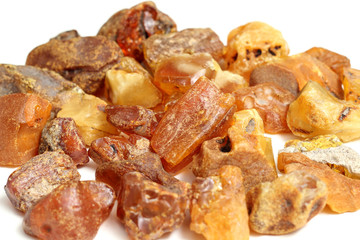 Natural raw amber stone isolated on white background. Multiple amber gemstone in various shapes and colour. Jewelry components.