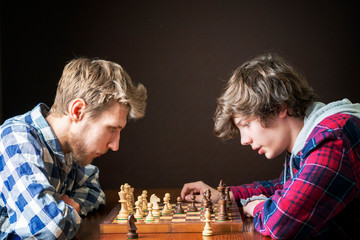 two chess players at a chess game in the evening