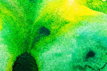 top view of yellow and green watercolor spills with copy space