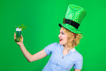 St Patrick's Day. Green top hat. Saint Patrick. Woman in top hat holds glass with green beer....