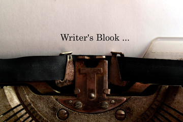 In the old typewriter inserted a white sheet of paper with the inscription: Writer's Blook ...