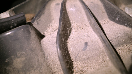 In a car garage under the hood is a very dirty car engine preparation for a full chemical cleaning. Concept of: Full number, Very dirty, Not safe, Car parts, Car wash, Garage.