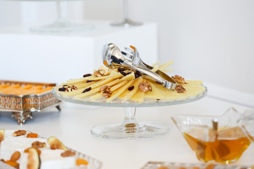 Plate with delicious cheese , nuts, peanuts and raisins