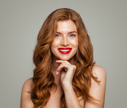 Happy red head woman smiling. Elegant redhead girl with curly hairstyle. Candid beauty