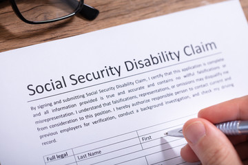 Person Filling Social Security Disability Claim Form