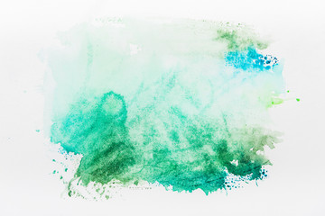 Top view of turquoise watercolor spill on white background