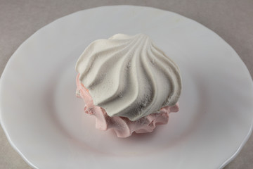 White - pink  zephyr, isolated on white dish close-up. Oriental sweets.