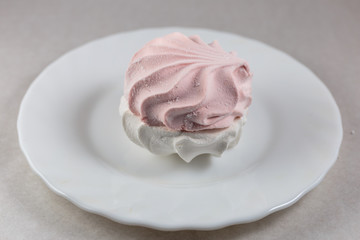 White - pink  zephyr, isolated on white dish close-up. Oriental sweets.