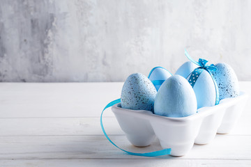 Organic blue easter eggs in porcelain decorative box on white. Holiday concept concept.