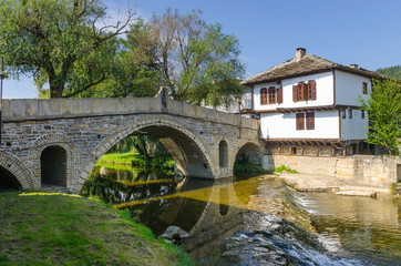 Fototapeta na wymiar Old bridge (also called hunchback bridge) on the Trevnenska river in the town of Tryavna