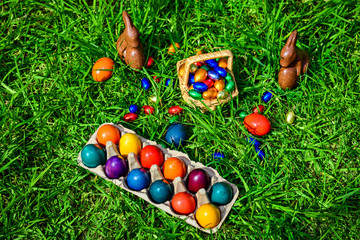 Fototapeta na wymiar Chocolate Easter bunnies with eggs in grass