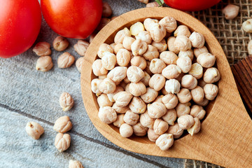 Uncooked raw chickpeas (Cicer arietinum) in wooden spoon