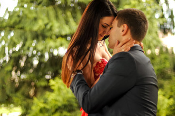 Close up romantic couple are hugging and enjoy each other in the park outdoor