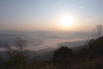 Layer of Mountain in morning sunrise and winter fog,